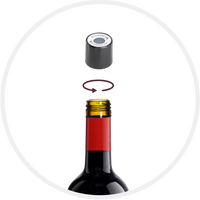 A black wine stopper above a bottle, demonstrating a twisting motion to seal or open the container.