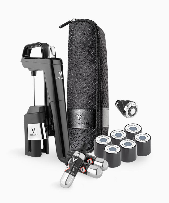 Coravin wine preservation system with black opener, carrying case, gas capsules, and pour spout.