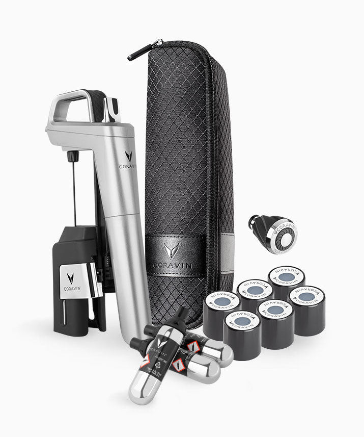 Coravin wine tool set with a silver opener, black storage case, gas cartridges, and wine preservation accessories.