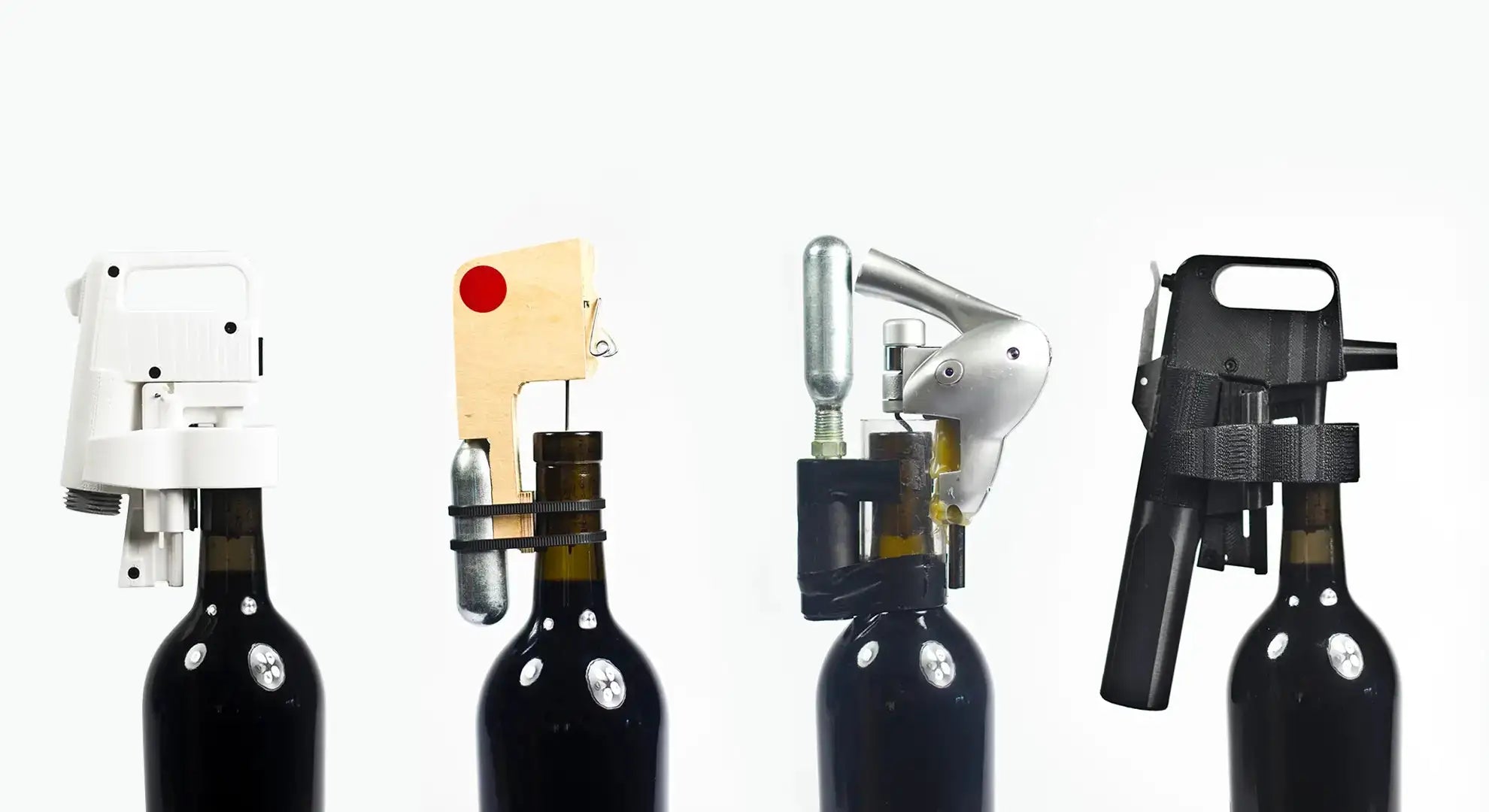 Four wine bottle openers are displayed, each with a unique design, positioned on black wine bottles against a white background.