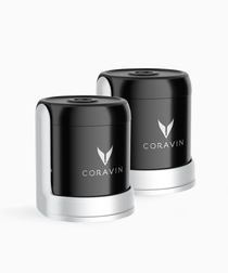 Two black Coravin wine preservation devices with silver bases, featuring the Coravin logo on the front.