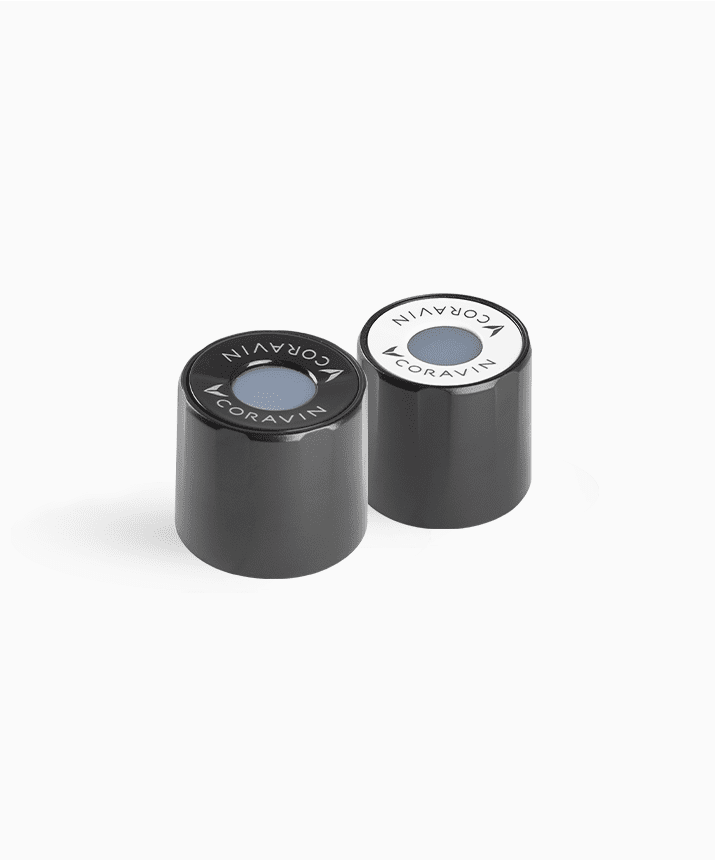 Two Coravin wine capsule tops with a black and white color scheme, featuring the Coravin logo on each.