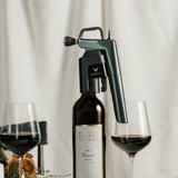 Coravin wine aerator on a bottle of 2017 Lowe Zinfandel, with two glasses of red wine and a candle in a dining setting.