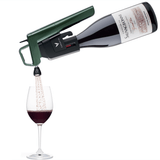 A Coravin wine pouring device dispensing red wine into a glass, showcasing the bottle label "Château La Sauvagonne."